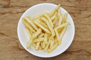 French fries on wood background