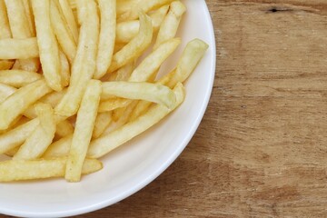 French fries on wood background