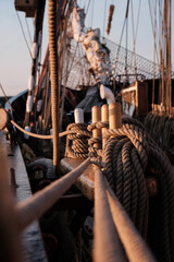 Closeup of ropes of an old sailing vessel with the bowsprit in background