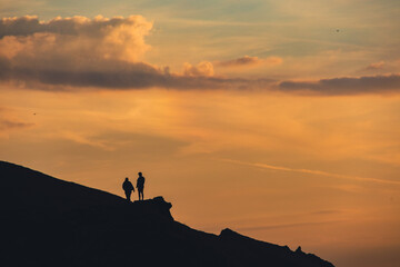 silhouette of a person on a rock