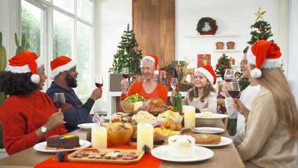 A group of multi ethnic. Portrait of Caucasian and African American black family, woman have a celebration dinner in party on Merry Christmas Eve Xmas on holiday at home.People lifestyle. thanksgiving