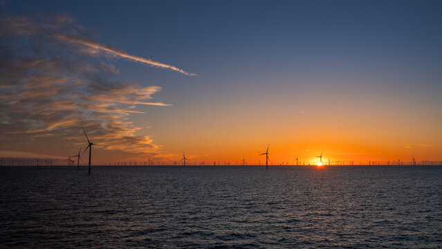 Beautiful night offshore with nice clouds around. Wind park.