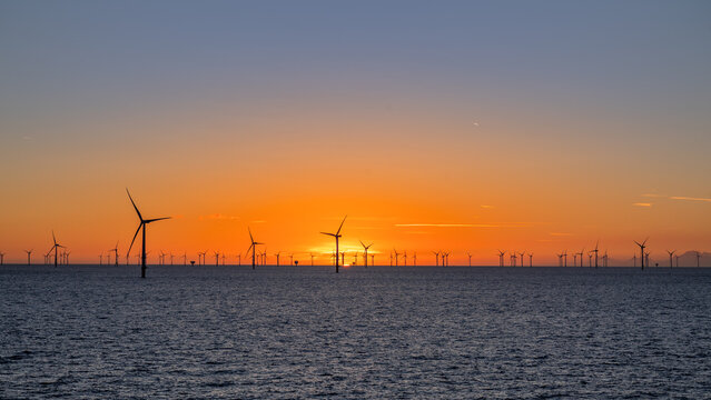 Beautiful night offshore with nice clouds around. Wind park.
