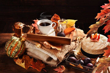 Autumn still life with a cup of coffee on a wooden tray