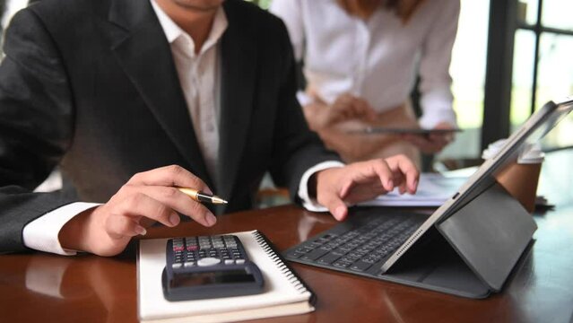 Woman accountant use Laptop and calculator to calculate the company's financial with icon banking on data network of finance and banking with business growth in office