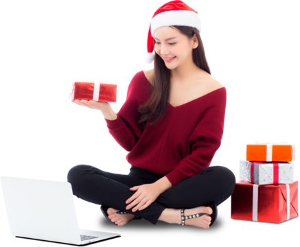 Young woman wear santa hat and gift box sitting labtop with internet shopping in season christmas holiday, girl shoping online on notebook in xmas, celebration concept.