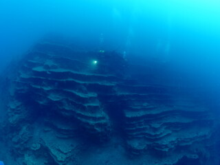 underwater scenery with strange rocks scuba divers around ocean scenery landscape topography...
