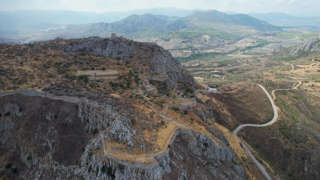 Aerial view of the imposing ancient site of Acrocorinth towards Corinth, Corinthia, Peloponnese, Greece, in summer. Sunny day over ancient fort