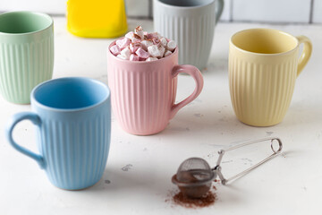 colorful mugs of hot chocolate with marshmellow