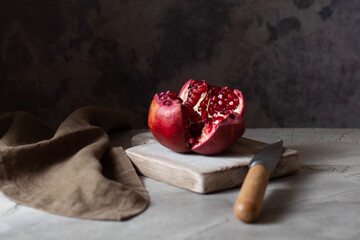 fresh rape pomegranate on a small cutting board