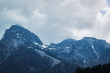 Naklejka premium Mountain landscape. Snowy peak. Fog and aerial perspective.