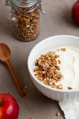 Healthy breakfast of apples, granola and yogurt