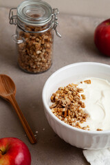 Healthy breakfast of apples, granola and yogurt