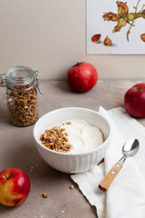 Healthy breakfast of apples, granola and yogurt