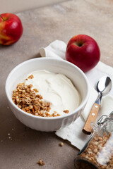 Healthy breakfast of apples, granola and yogurt