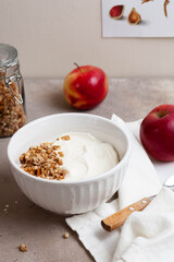 Healthy breakfast of apples, granola and yogurt