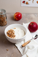 Healthy breakfast of apples, granola and yogurt