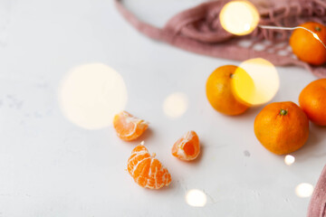 mandarins in a pink string bag and garland light bokeh