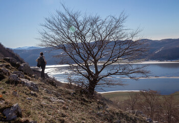 hiker on mountain peak and lake matese