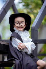 Asian children boy in Count Dracula dress costume for Halloween decoration in graden