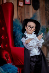 Asian children boy in Count Dracula dress costume for Halloween decoration in graden
