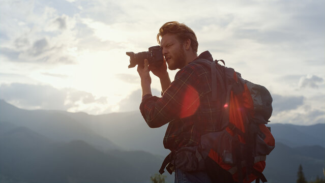Closeup young tourist make photo at mountains scenery. Photographer at nature.