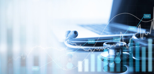 Healthcare business concept. Stethoscope and laptop computer with medical financial graph growth...