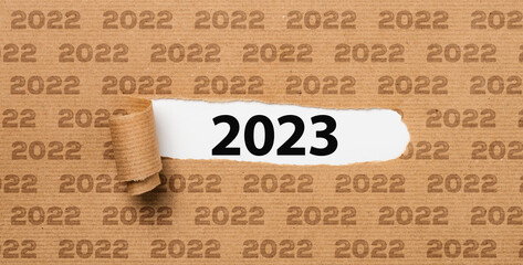  Torn  paper revealing the number 2023