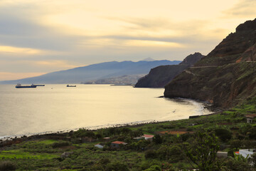 At sunset the shadows cover Igueste de San Andr&eacute;s, a small village at the foot of the Anaga mountains. In the background, the city of Santa Cruz, and further still Teide
