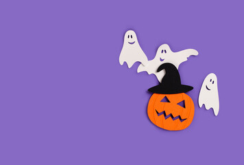 Halloween banner with paper pumpkin and ghosts on purple background.