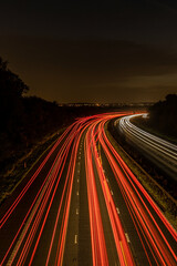 High angle view of nighttime traffic on motorway  - obrazy, fototapety, plakaty