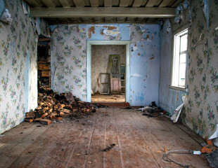 Fototapeta na wymiar Inside an abandoned farmhouse. Wooden cottage in small abandoned village. Grunge background.