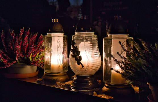 candles on the cemetery on the grave at night, all Saints Day