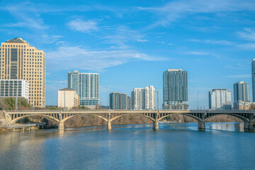 Fototapeta na wymiar Austin, Texas- bridge over the Colorado River below the cityscape views against the sky