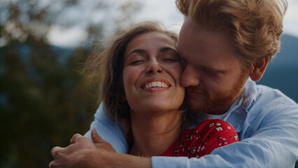 Just married couple kissing in mountains. Tender lovers enjoying family vacation