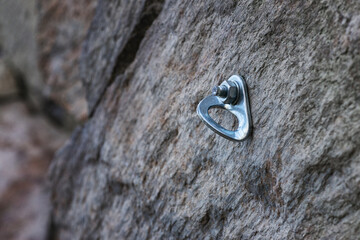 Rock Climbing Anchor Bolt in Granite Rock Face.
Close-up of a reusable climbing bolt on a rock....