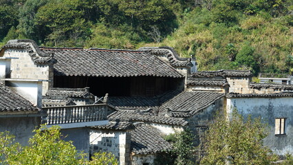 Fototapeta premium The beautiful traditional Chinese village view with the classical architecture and fresh green trees as background