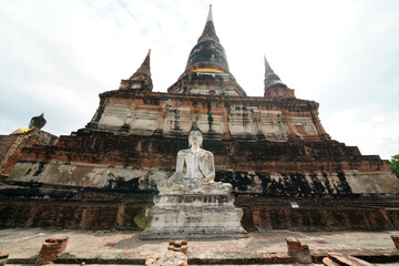 Ruins of pagodas, monks and walls that remain of Wat Yai Chaimongkol, Ayutthaya, Thailand, were...