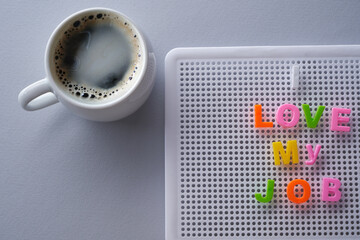 i love my job message and cup of coffee on letter board