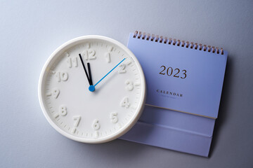 count down to year 2023- 12 o'clock wall clock and 2023 desk calendar