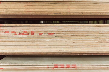Stocked plywood sheets of differing thickness at an open-air hardware store.