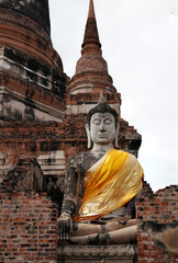 Ruins of pagodas, monks and walls that remain of Wat Yai Chaimongkol, Ayutthaya, Thailand, were...