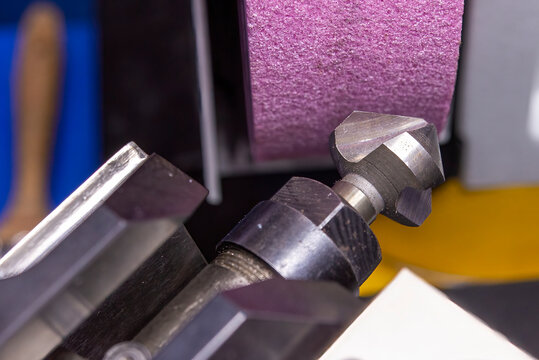 Close-up scene the chamfer tool grinding process.