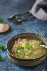 A bowl with chicken soup with pasta