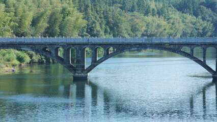 Fototapeta na wymiar The old arched stone bridge view located in the countryside of the China