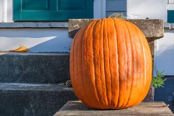 Single uncarved pumpkin on front porch of historic uptown New Orleans home