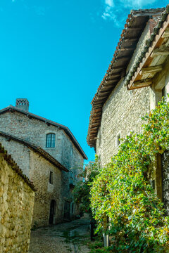Old medieval street with stone houses, between light and shadow, in the famous village P&eacute;rouges, Ain, Auvergne Rh&ocirc;ne Alpes, France.