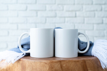 white mugs with scarf on wooden modern table