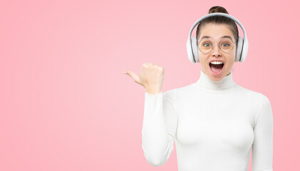 Banner of shocked girl listening to music in headphones, showing to copy space with wow face