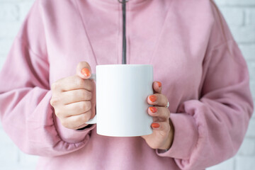 closeup woman hands holding white mug for mockup design